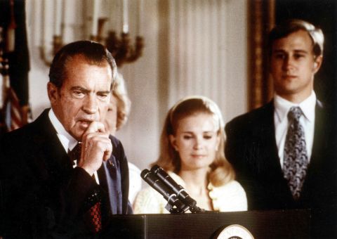 President Richard Nixon resigned his office after being implicated in a cover-up  following a burglary at political offices in the Watergate building.