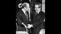 washington, UNITED STATES:  (FILES) This file picture shows US vice-president Gerald Ford (L) shaking hands with former US president Richard Nixon in Washington, 06 December 1973.  Ford, who sought to heal America after the trauma of the Watergate scandal that forced Richard Nixon from office in 1974, died 26 December 2006, his wife said. He was 93. Ford lost the 1976 election campaign to Jimmy Carter, a defeat that historians have attributed to his decision to pardon Nixon for his crimes barely a month after taking office.  AFP    PHOTO   FILES/STR       (B/W ONLY)  (Photo credit should read STR/AFP/Getty Images)