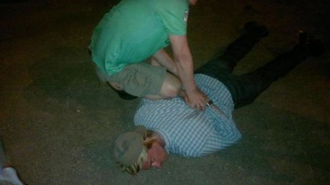 Russia's FSB counterintelligence agency released photos after it said it briefly detained a suspected member of the CIA who was trying to recruit a staff member of one of the Russian special services. Pictured, the man is handcuffed on the ground.