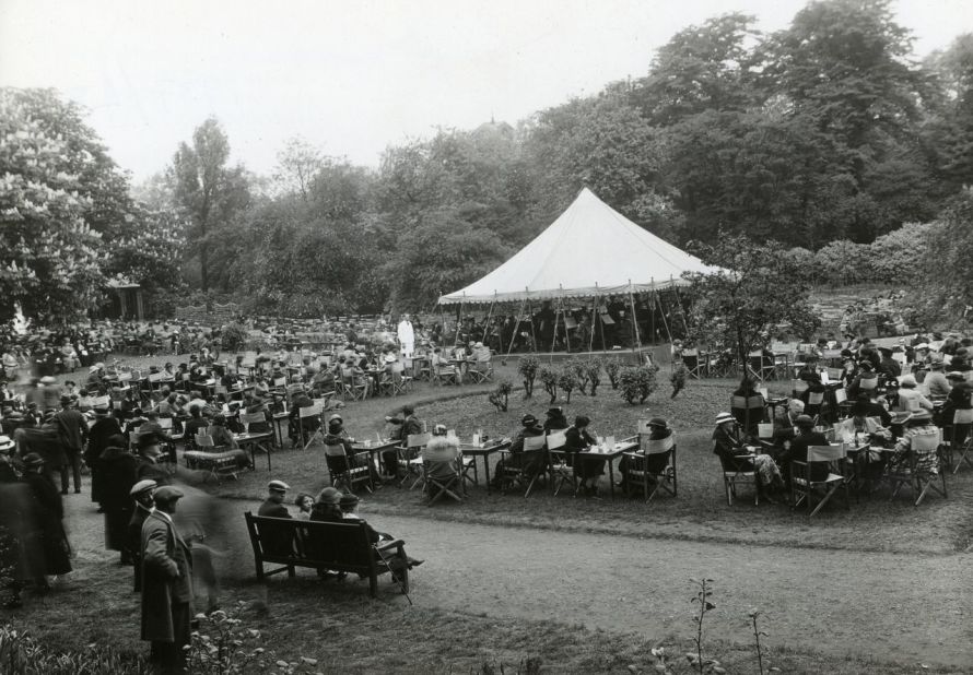 Visitors relax to the sound of a band playing in the 1937 Chelsea Flower Show