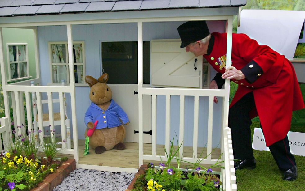 In their distinctive red coats, old soldiers called Chelsea Pensioners are a familiar sight at Chelsea. Here, one comes face to face with the Beatrix Potter character Peter Rabbit, in 2003.