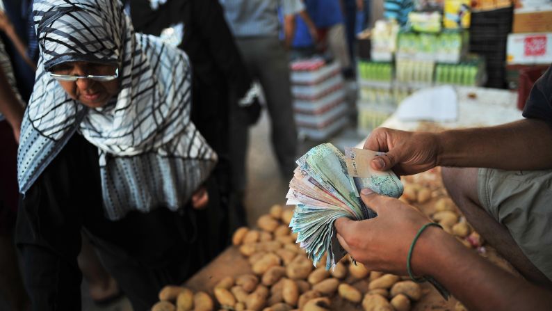 A vendor sells potatoes at the Rashid Street market in Tripoli on August 29, 2011.
