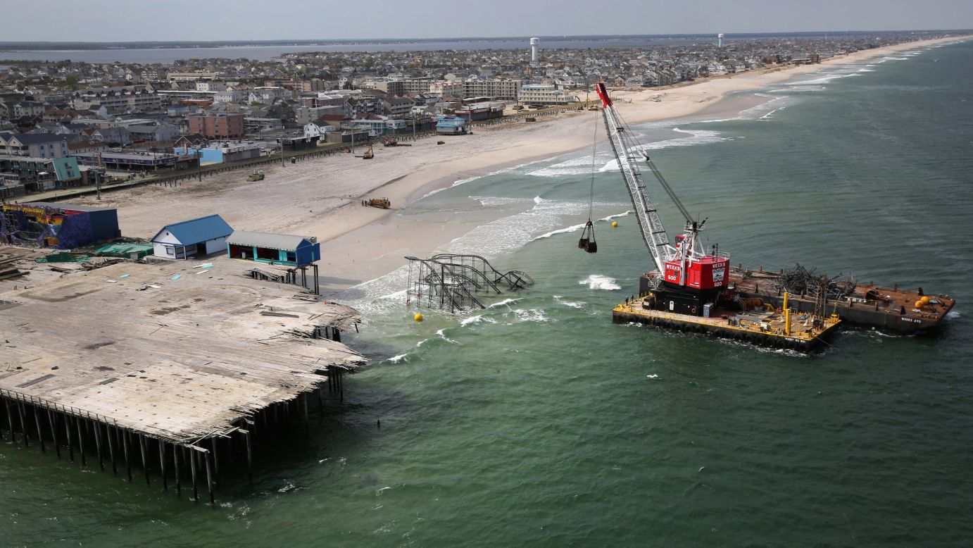 A crane demolishes the Jet Star roller coaster on Tuesday, May 14, 2013, in Seaside Heights, New Jersey, almost seven months after it fell into the ocean during Superstorm Sandy.