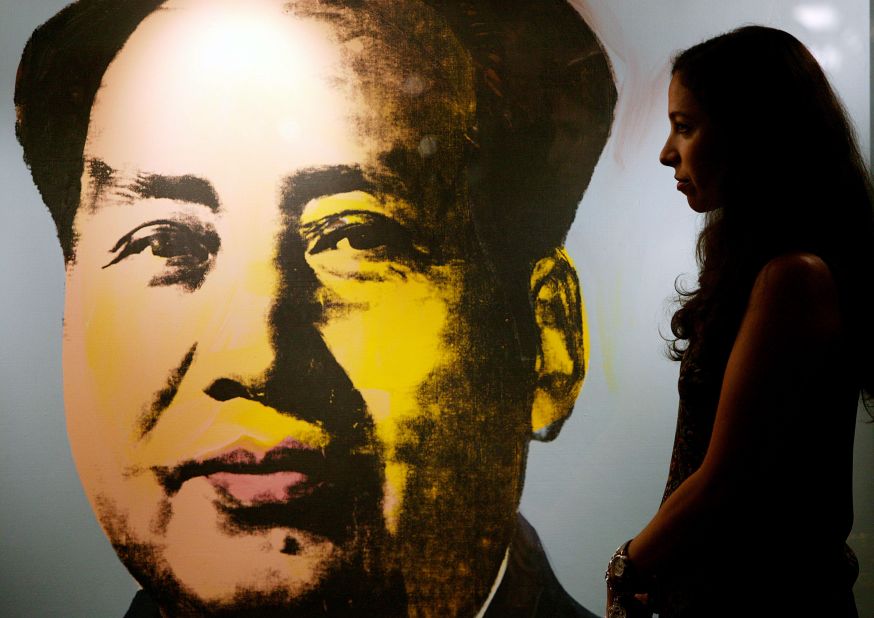 A Christie's art expert walks by a Mao portrait by Andy Warhol at a press preview in Hong Kong in October 2006.  The piece was auctioned to Hong Kong property tycoon Joseph Lau for US$ 17.4 million the  following month in New York, setting a world auction record for the artists.