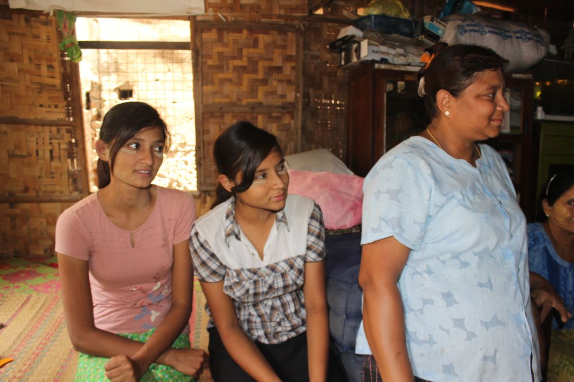 Thidar Hla (right) pictured at home in Meiktila with her two daughters: Hnin Ei Phyu (far left) and Moe Ei Phyu. They are one of thousands of families was forced to flee during clashes between Muslims and Buddhists.