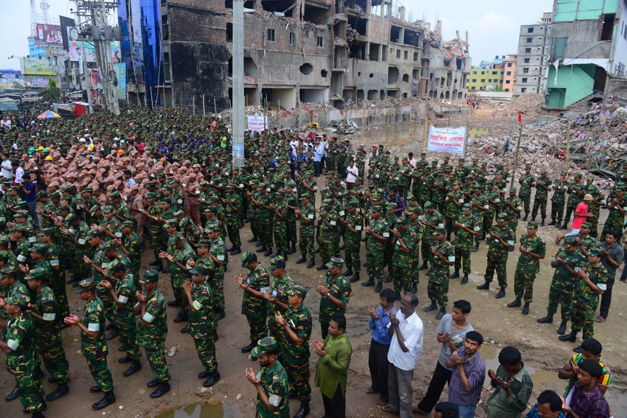 Members of the Bangladesh army pray at the site of the collapsed Rana Plaza in Savar near Dhaka on Tuesday, May 14. The army-led effort to search for bodies has ended nearly three weeks after the nine-story building collapsed. <a href="http://www.cnn.com/2013/05/14/world/asia/bangladesh-building-collapse-aftermath/?hpt=hp_t2">The final death toll stands at 1,127</a>.