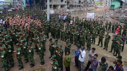 Members of the Bangladesh army pray at the site of the collapsed Rana Plaza in Savar near Dhaka on Tuesday, May 14. The army-led effort to search for bodies has ended nearly three weeks after the nine-story building collapsed. The final death toll stands at 1,127.