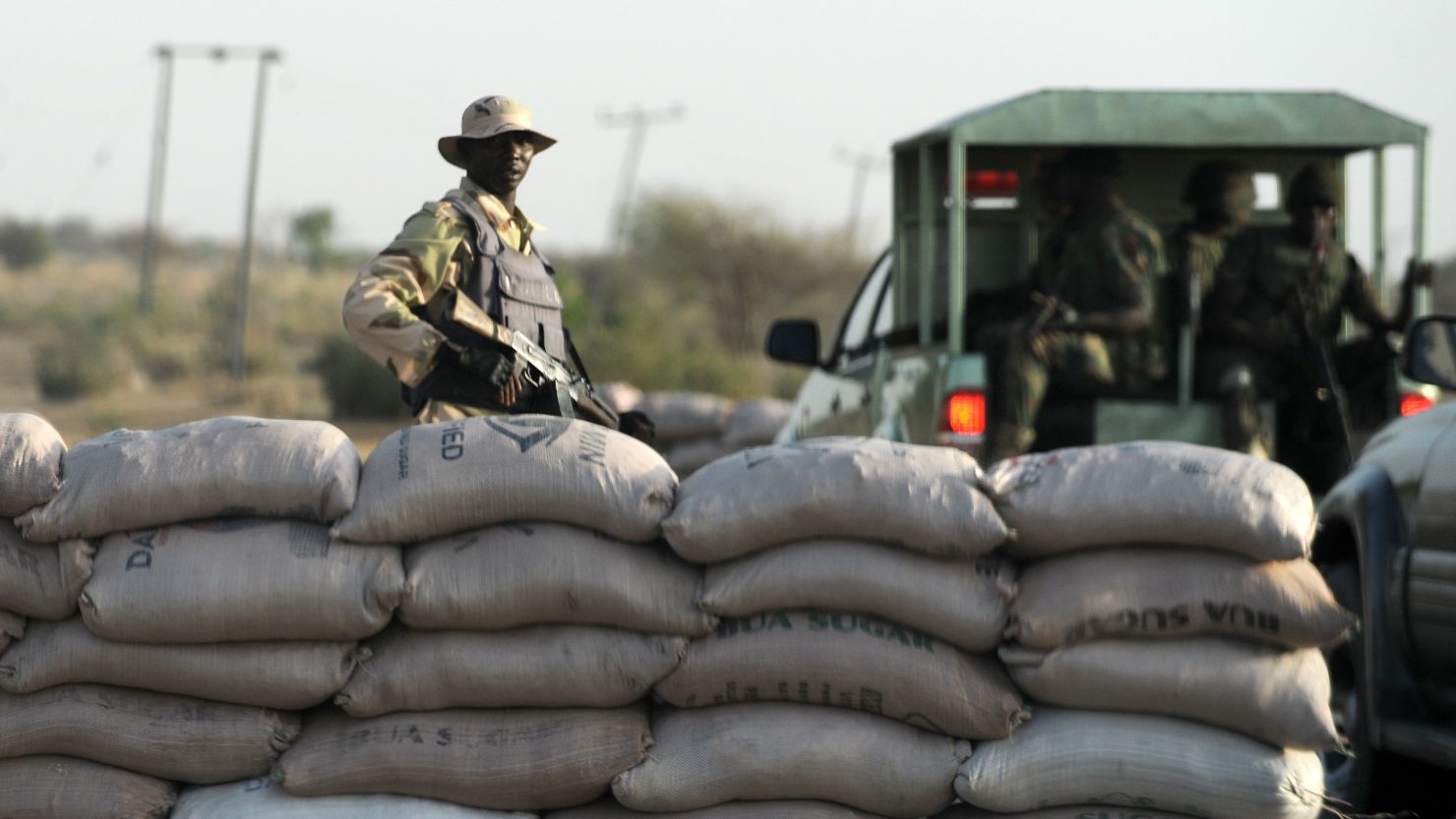 An officer of the Joint Military Task Force (JTF) stands beside sand bags at a road block in the northeastern Nigerian town of Maiduguri, Borno State , on April 30, 2013. Fierce fighting between Nigerian troops and suspected Islamist insurgents, Boko Haram at Baga town in the restive northeastern Nigeria, on April 30, 2013 left dozens of people dead and scores of civilians injured. But the military denied the casualty figures claiming it was exaggerated to smear its image. Meanwhile normalcy has return to the town as residents are going about their normal business. AFP PHOTO/PIUS UTOMI EKPEI (Photo credit should read PIUS UTOMI EKPEI/AFP/Getty Images)