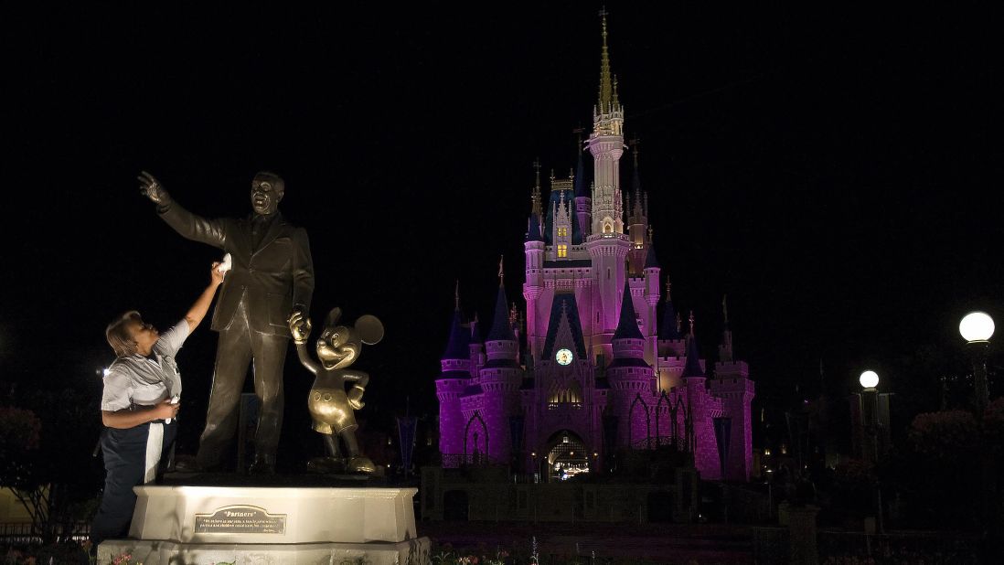 1. It takes many hands to keep the Magic Kingdom in Florida on top as  the No. 1 amusement park in the world. Here a custodian polishes the Walt Disney and Mickey Mouse statue at the Orlando park. 