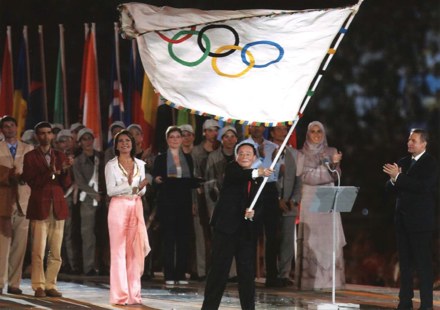 Angelopoulos hands over the Olympic flag to Beijing at the Athens 2004  closing ceremony.