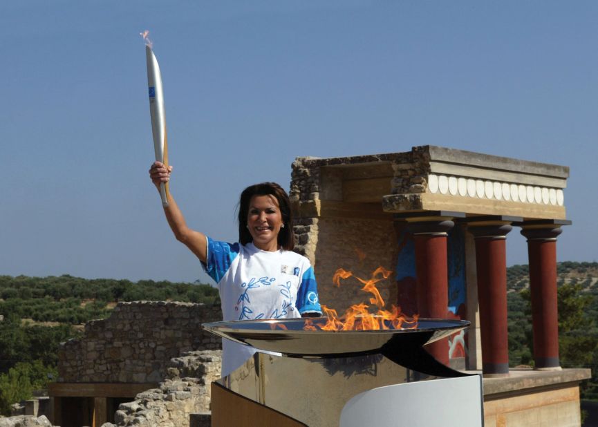 Holding an Olympic torch at the palace of Knossos in her hometown of Heraklion, Crete,  Angelopoulos is content.