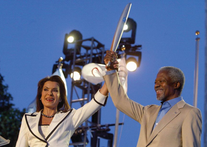 As head of the Athens 2004 Organizing Committee, Angelopoulos lifts the Olympic torch with Kofi Annan, the then Secretary General of the United Nations.