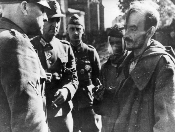 Only a handful of fighters survived the uprising.Pictured here is a Polish prisoner of war (right) being interrogated by German officers in Warsaw.