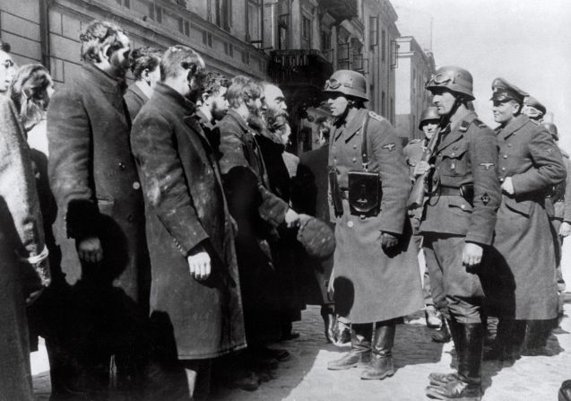 The revolt was crushed by German troops under the command of SS-Gruppenfuehrer Juergen Stroop during April and May 1943. Here German soldiers question prisoners after the uprising.