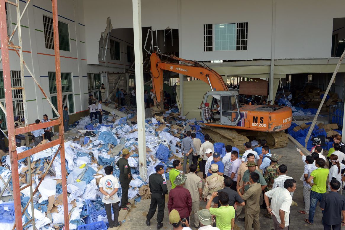 Cambodian rescue team and soldiers look for workers who may have been trapped by the walkway collapse at the Wing Star Shoe Co. factory on May 16.