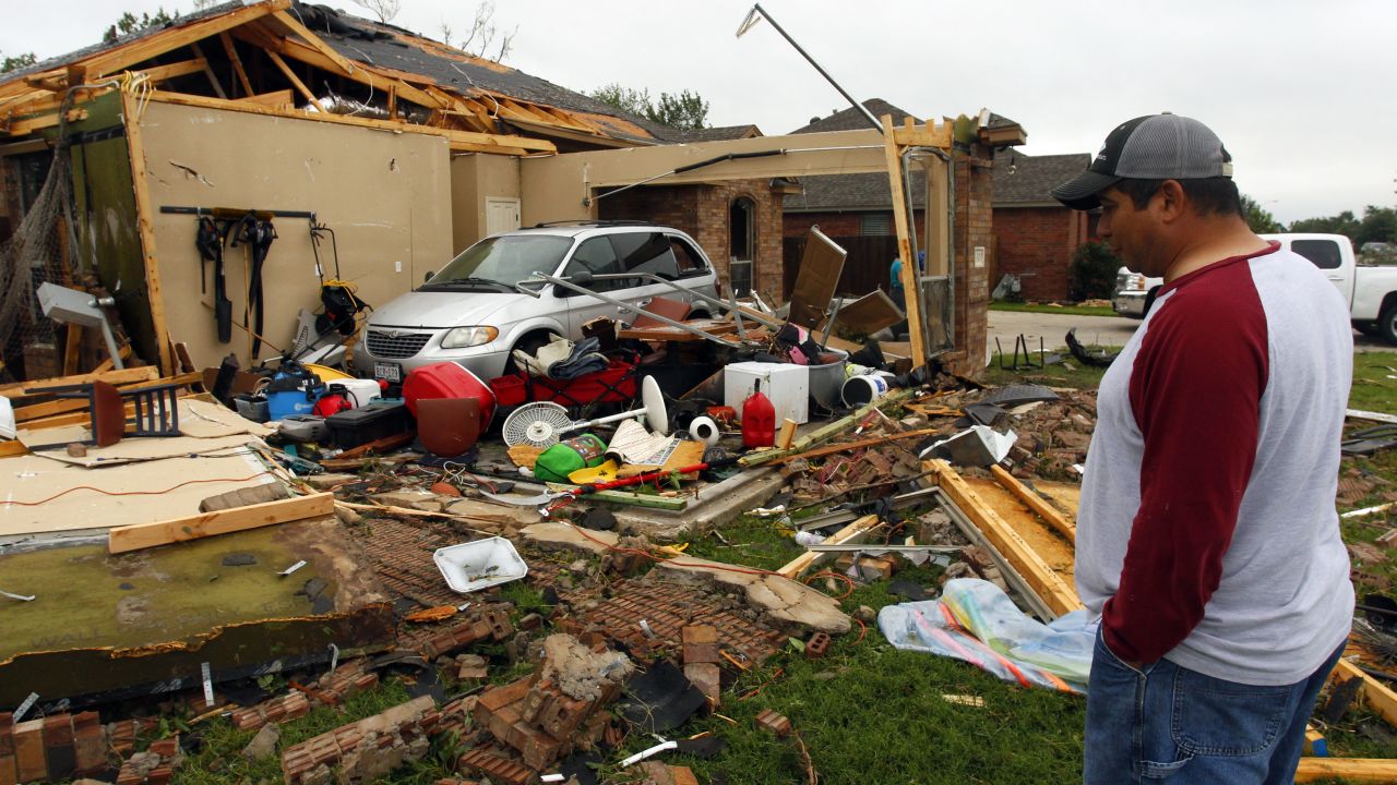 Pete Alaniz eyes damage to the garage of his Cleburne, Texas, rental home on May 16.