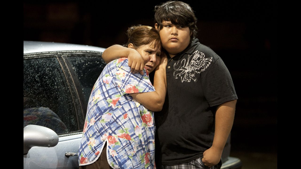 Eva Zapata, left, waits with a relative, Dario Segura, on May 15 for news of her children, who live in the Granbury neighborhood of Rancho Brazos. Six of the storm victims came from that subdivision, the Hood County sheriff said.