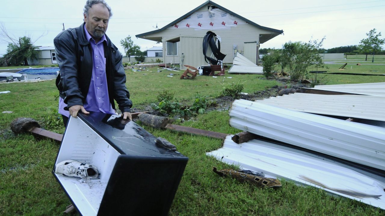 John Bouyer collects a refrigerator on May 16 that blew away from his sister-in-law's home in Granbury.