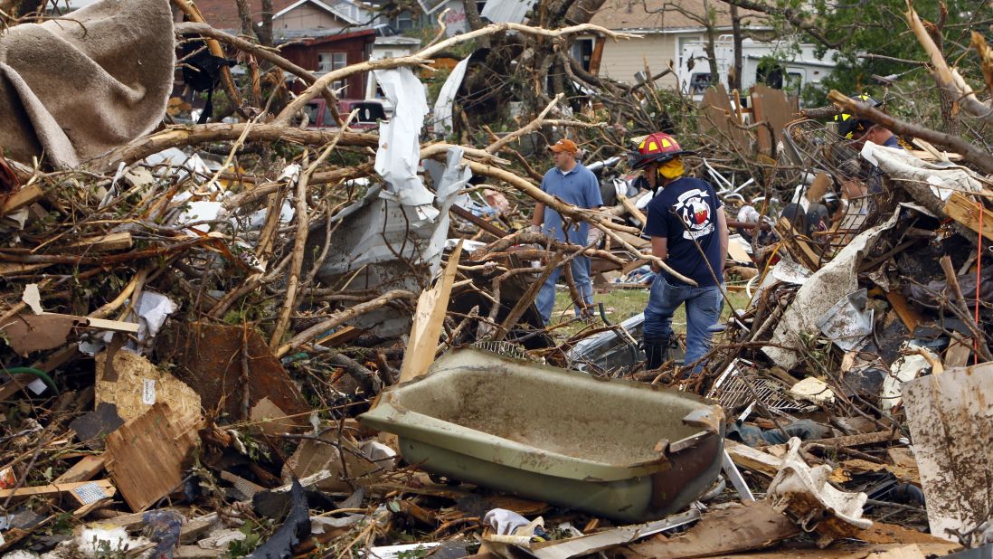 Rescue workers search through debris in Granbury, on May 16.