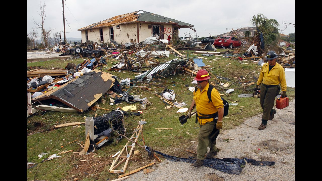 Rescue personnel pass remnants of destroyed houses in Granbury on May 16. There were reports of homes in Granbury being flattened with people inside.