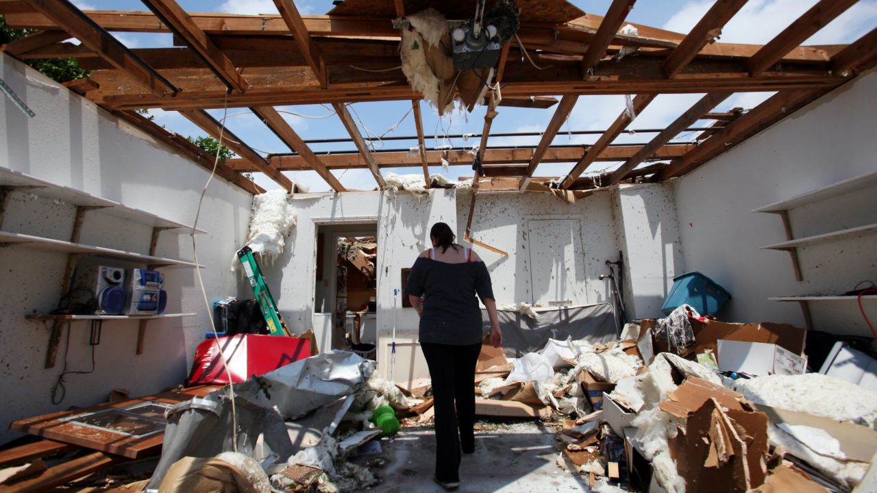 Beth Poledna walks through her garage on May 16 in Cleburne, Texas, as she begins the cleanup after a tornado swept through the area. 