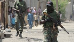 Soldiers walk on April 30, 2013 in the street in the remote northeast town of Baga, Borno State.