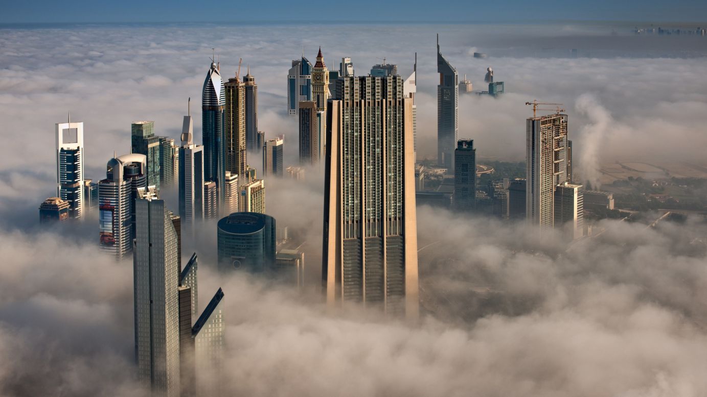 Looking north from the 101st floor of the Burj Khalifa, the Index Tower, center, and other skyscrapers stand high above the clouds.