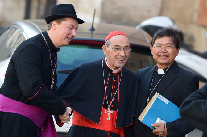 Ralph Napierski -- a fake bishop -- poses with Cardinal Sergio Sebiastiana as the cardinal arrives for talks ahead of a conclave to elect a new pope on March 4, 2013 at the Vatican.