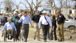 Texas Gov. Rick Perry, center, and Texas Attorney General Greg Abbott, left, survey the tornado damage in the Rancho Brazos Estates subdivision near Granbury, Texas, on Friday, May 17. At least six people were killed in a string of tornadoes that struck overnight Wednesday in North Texas.