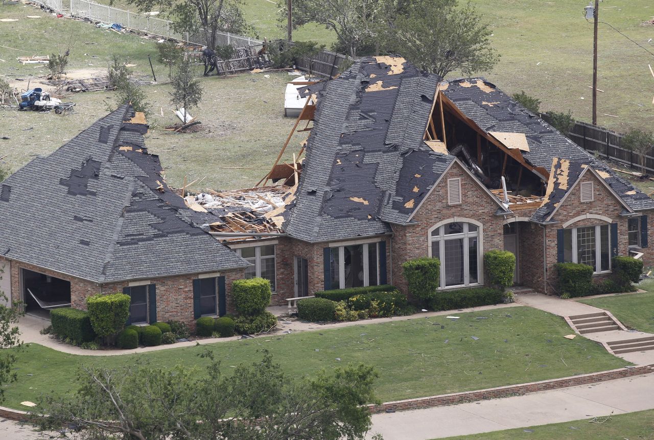 A heavily damaged home can be seen in this aerial view on Thursday, May 16, in Cleburne, Texas.
