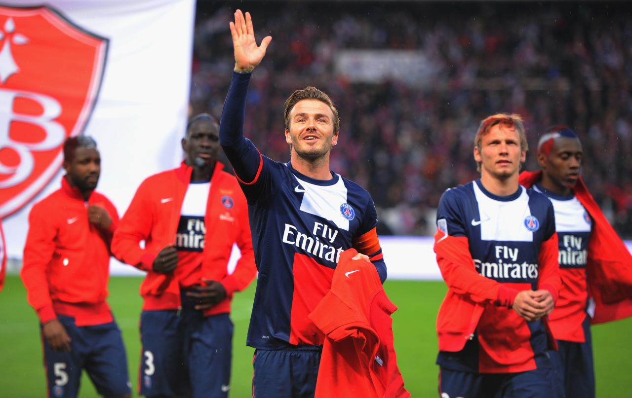 Beckham waves to his family and friends ahead of the match against Brest.