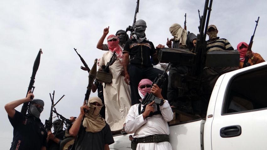 Iraqi armed tribesmen pose for a picture on the back of a truck in a road north of Ramadi, on May 18, 2013. The area is one of the main centres of the Sunni protest movement in Iraq, which began almost five months ago, as demonstrators from the Sunni Arab minority accuse the authorities of marginalising and targeting their community.