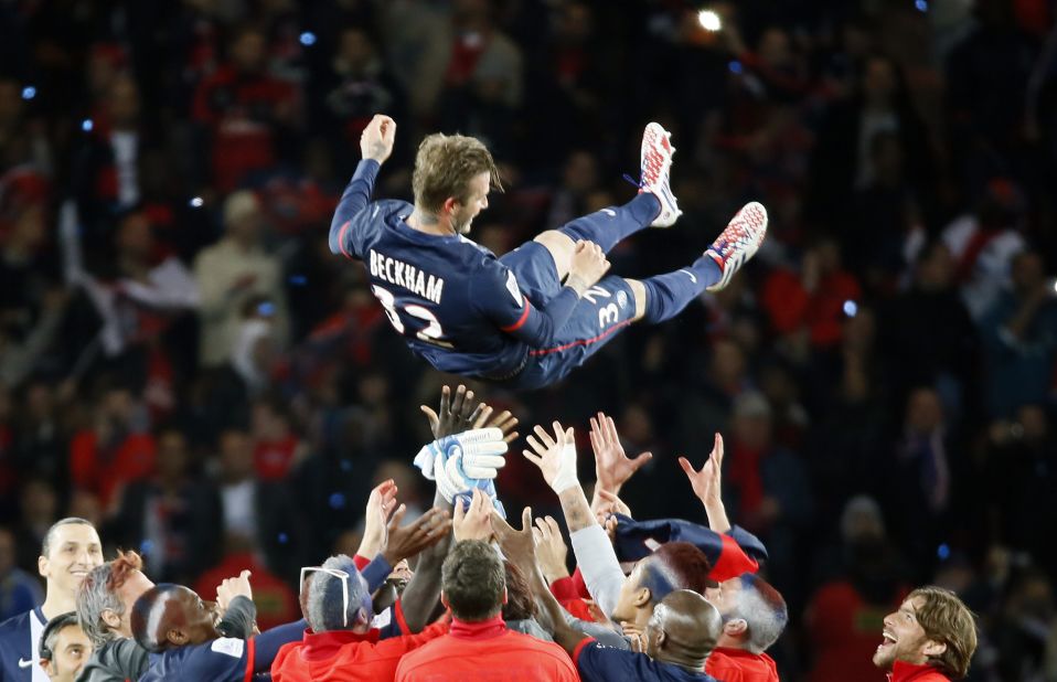 Beckham's teammates lift him high after their 3-1 win over Brest in the Parc des Princes. 