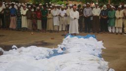 Bangladeshi men pray in front of the bodies of victims of Cyclone Mahasen in Tekna, south of Dhaka, on Friday, May 17. The bodies washed up on the shores of Bangladesh after the victims' boat capsized while sailing from Myanmar. At least 12 deaths have been reported in Bangladesh due to the cyclone.