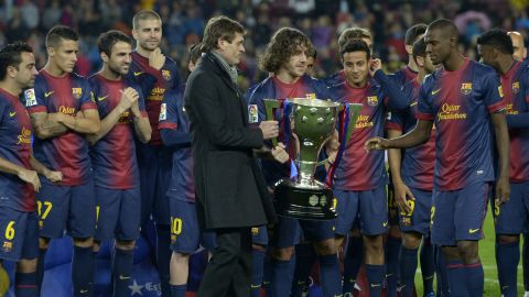 Carlos Puyol allows Tito Vilanova and Eric Abidal to lift the La Liga trophy in the Nou Camp.