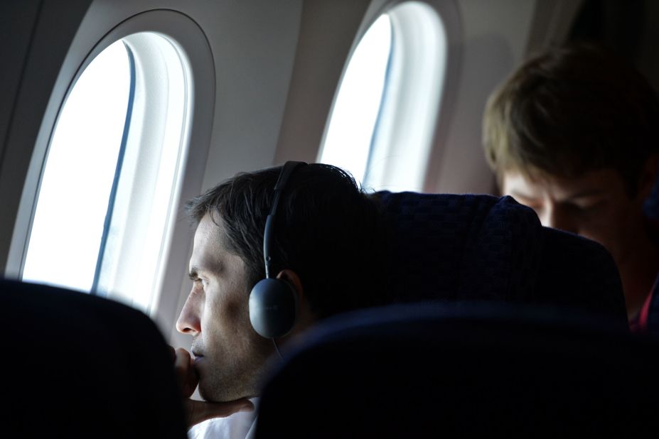 A passenger on United Airlines Flight 1 looks out one of the Dreamliner's oversized windows. The use of composite materials to build the airplane made larger window cutouts possible.