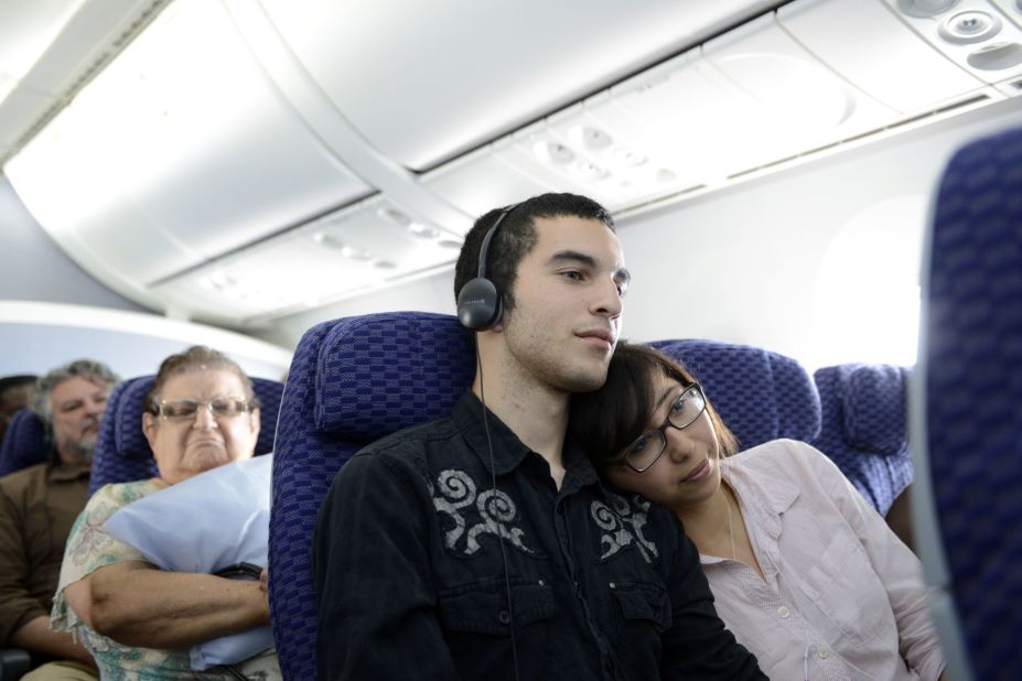 Alex Gilbert and Rebecca Davila watch a film during a flight on a Boeing 787Dreamliner.