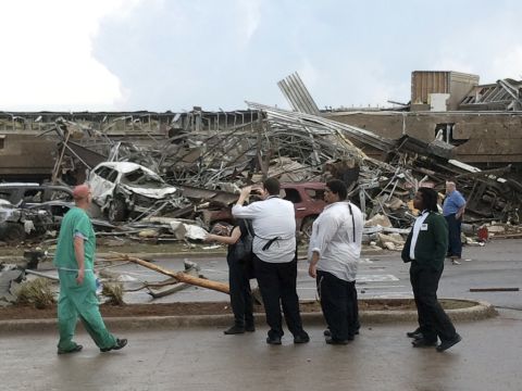 Onlookers stop to view a portion of the destruction left behind on May 20 in Moore.