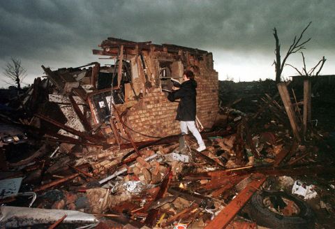 Peggy Lipscomb salvages belongings from what is left of her home in southeast Oklahoma City on May 4, 1999, following a series of deadly tornadoes that tore through the state.