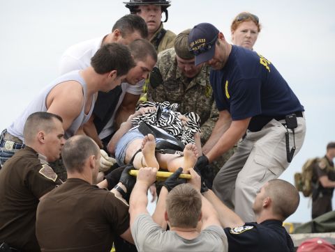 A woman is transported on a stretcher after she was rescued from the damaged medical center in Moore on May 20.