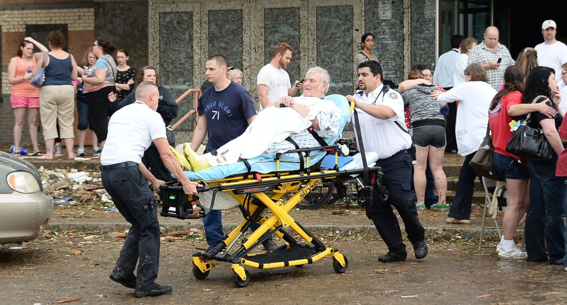 A man is taken away from the IMAX Theater in Moore that was used as a triage center on May 20.