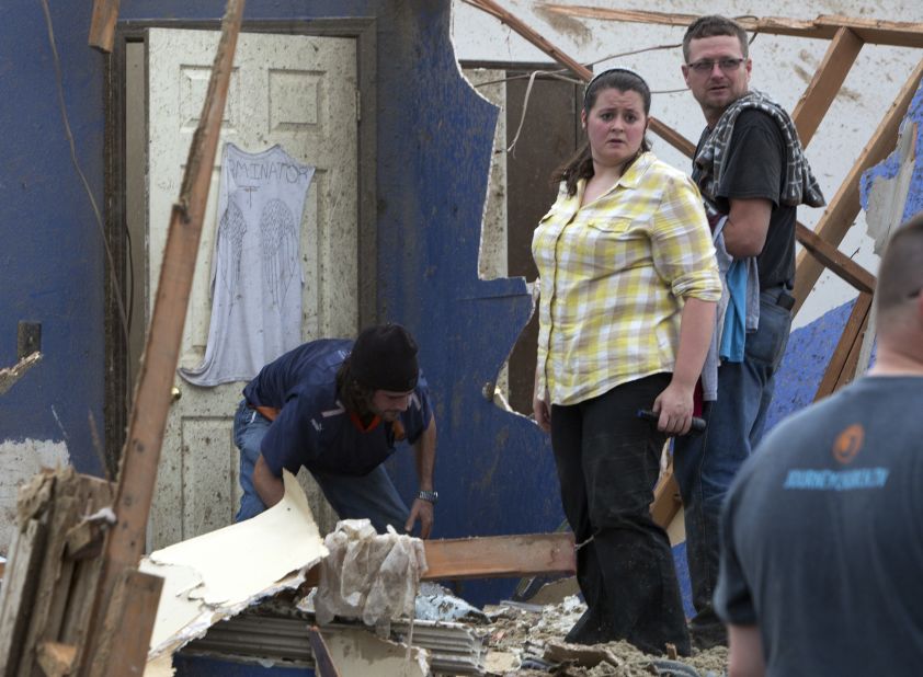 Residents look through the debris in Moore on May 20.