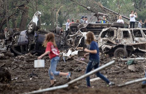 People look through the wreckage of their neighborhood after a tornado struck Moore, Oklahoma, on May 20.