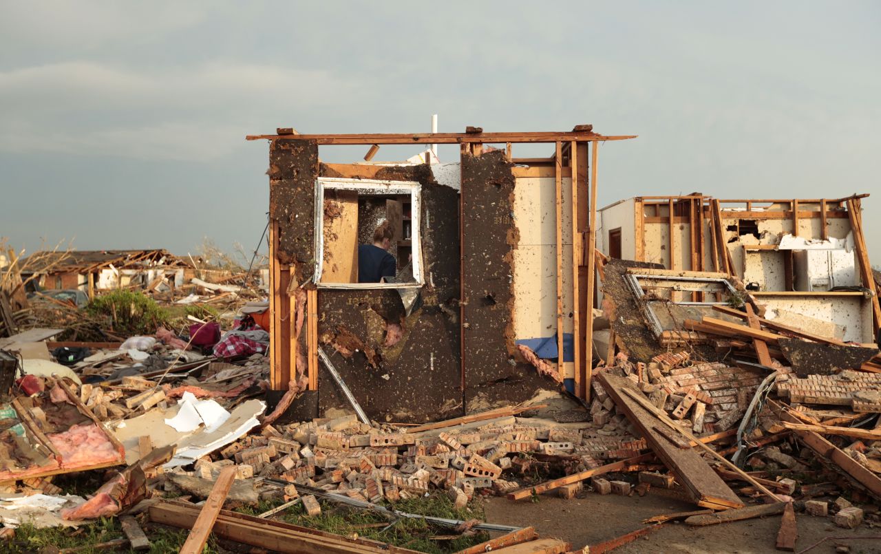 Dana Ulepich searches inside a room left standing at the back of her destroyed house in Moore on May 20.