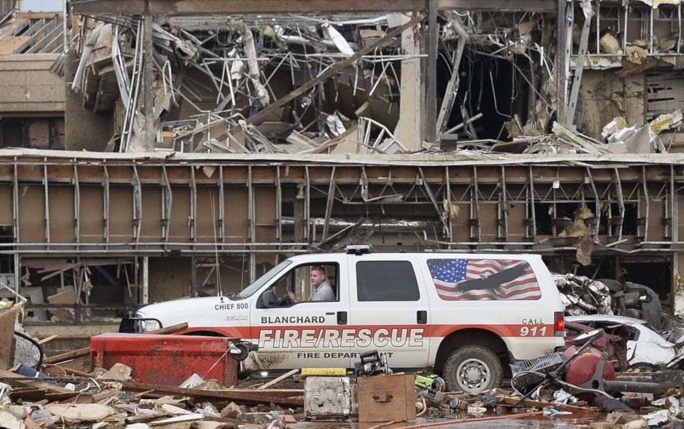 A fire official drives through the rubble of Moore Medical Center on May 20.