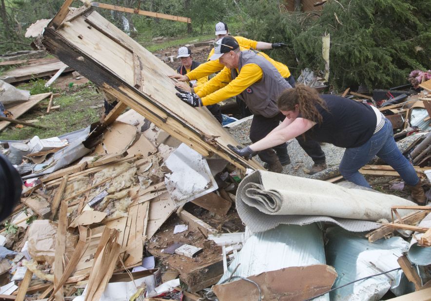 Rescuers search through rubble in Shawnee, Oklahoma, on Monday, May 20. A tornado outbreak hit in the Midwest and Plains on Sunday and Monday, the deadliest hitting Moore, Oklahoma, on Monday.