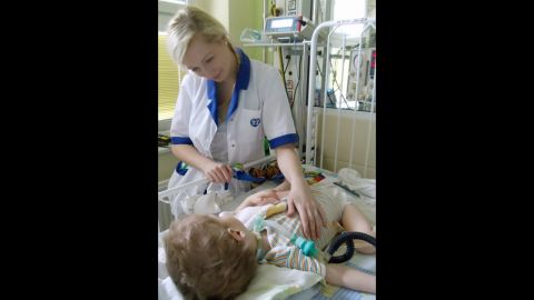 Nurse Katarzyna Kaseja, 25, comforts a patient at a Poznan, Poland, hospital.