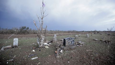 Debris lies among headstones in the Moore Cemetery on May 21.