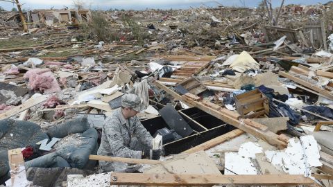 Air Force Airman First Class Justin Acord sifts through the rubble of his father-in-law's home in Moore on May 21.