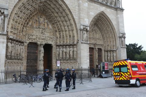 French police stand outside Paris' Notre Dame Cathedral on Tuesday, May 21, following the evacuation of the cathedral after a man shot himself dead in front of the altar. Historian and writer Dominique Venner killed himself in front of horrified tourists after denouncing same-sex marriage and immigration. 